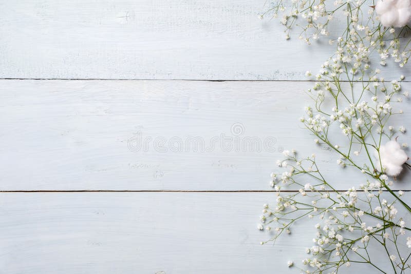 Spring background. White rustic flowers on blue wooden table. Banner mockup for womans or mother day, happy easter, spring holidays. Backdrop with copy space. Spring background. White rustic flowers on blue wooden table. Banner mockup for womans or mother day, happy easter, spring holidays. Backdrop with copy space